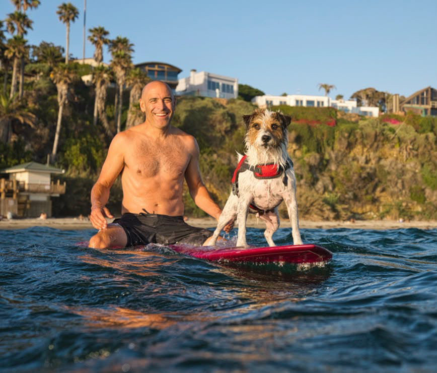 Max and his person on a surfboard in the water